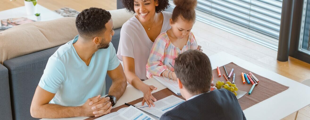 Banker consulting married couple in their home
